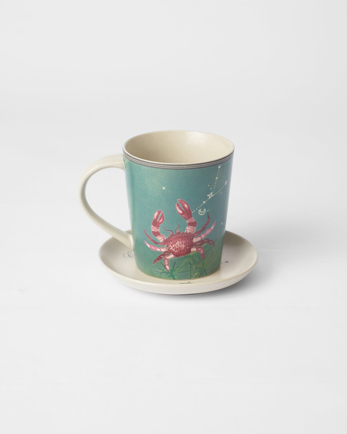 Nico Cancer mug on its plate featuring a red crab.