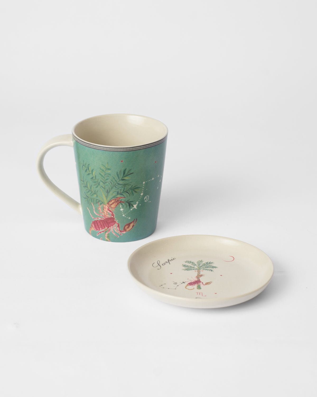 Nico Scorpio mug with a scorpion print beside a matching tea plate.