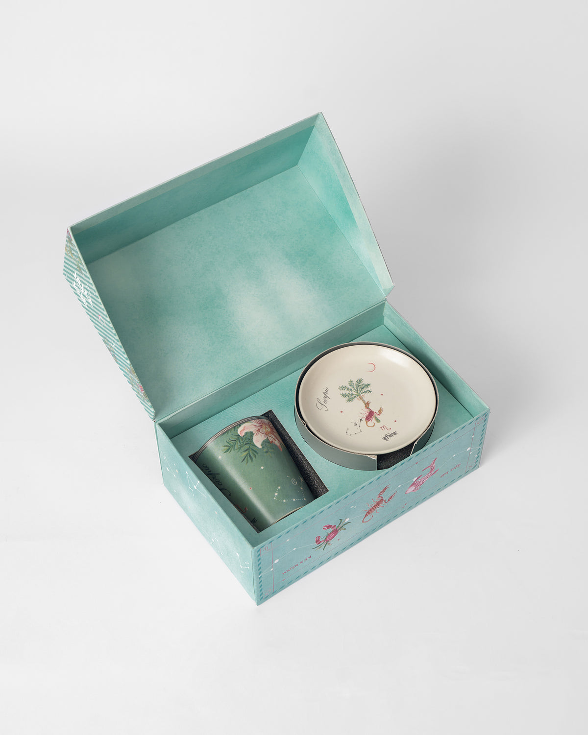 Nico Scorpio mug and tea plate packed in an open Nicobar gift box.