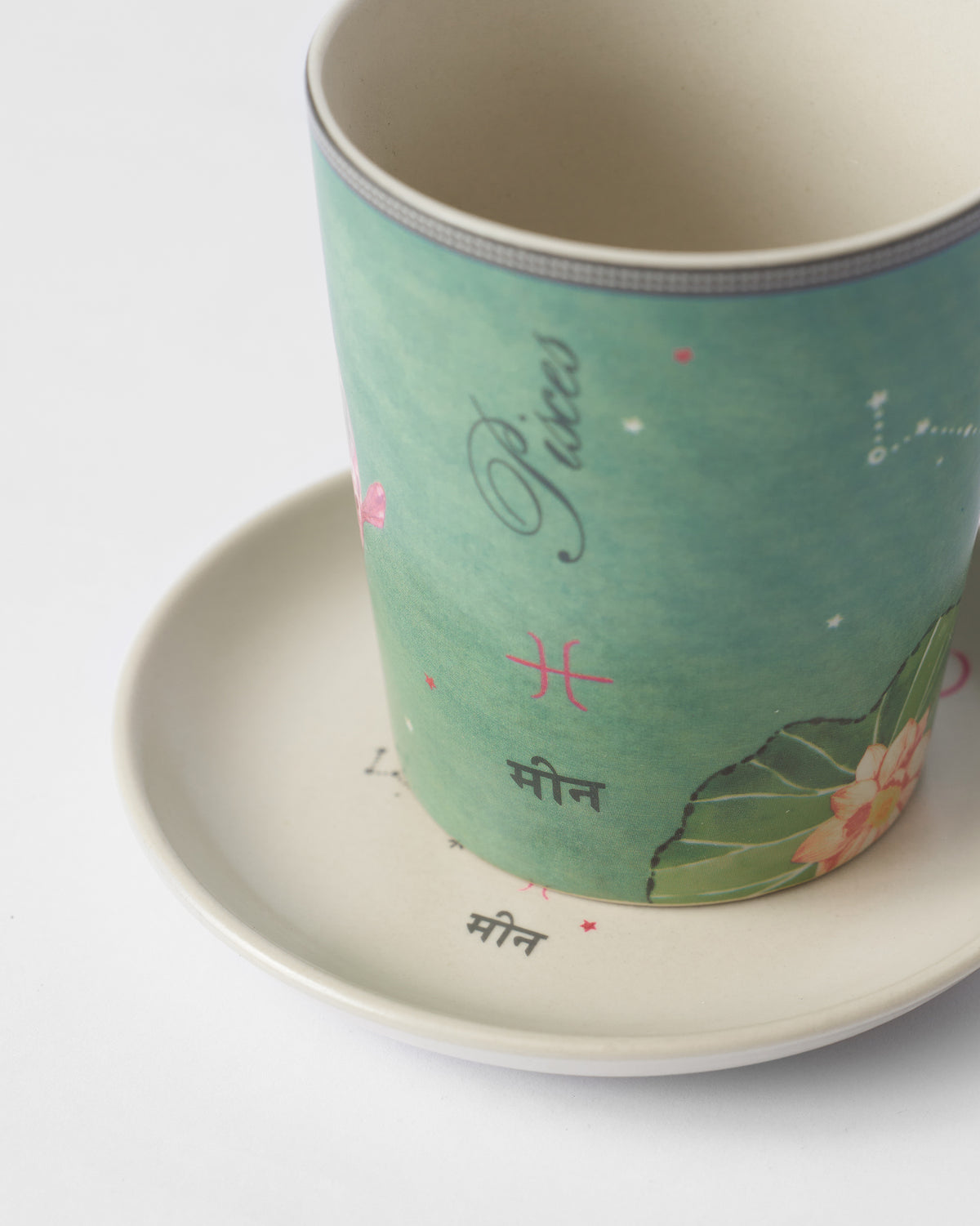 Close-up of the Nico Pisces mug rim, showing Pisces lettering and star markings.