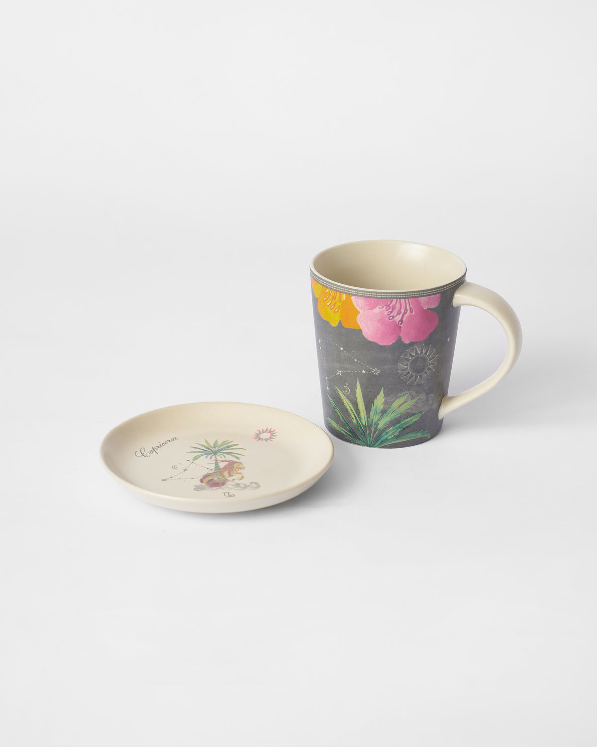 Nico Capricorn Gift Set floral mug beside Capricorn tea plate.