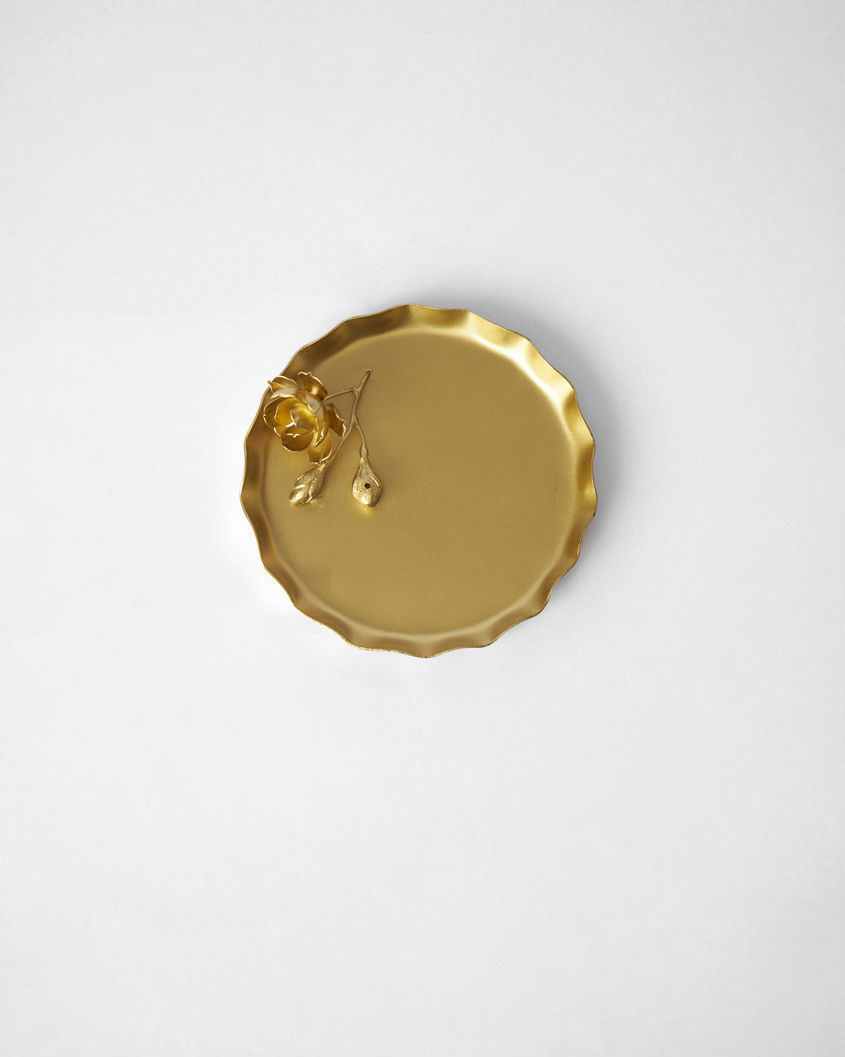 Grove Incense Holder seen from above, with a gold flower at one edge.