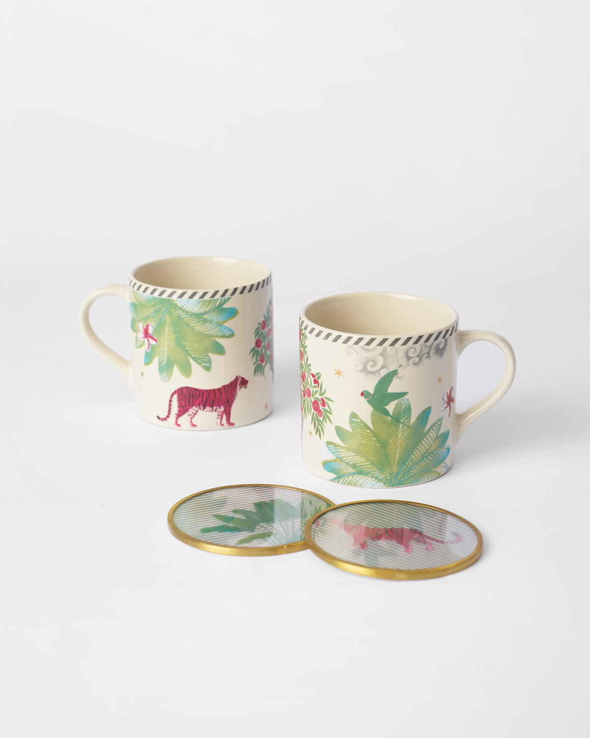 Two Ceylon Lush mugs with palm and animal motifs, with two coasters in front.