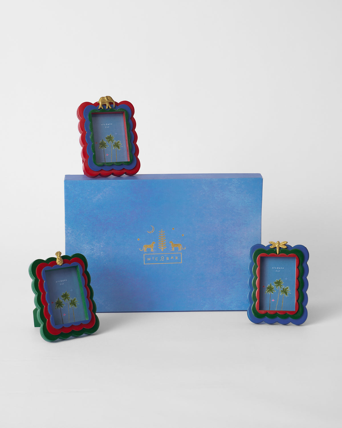 Tropics gift set of three photo frames beside a blue Nicobar box.