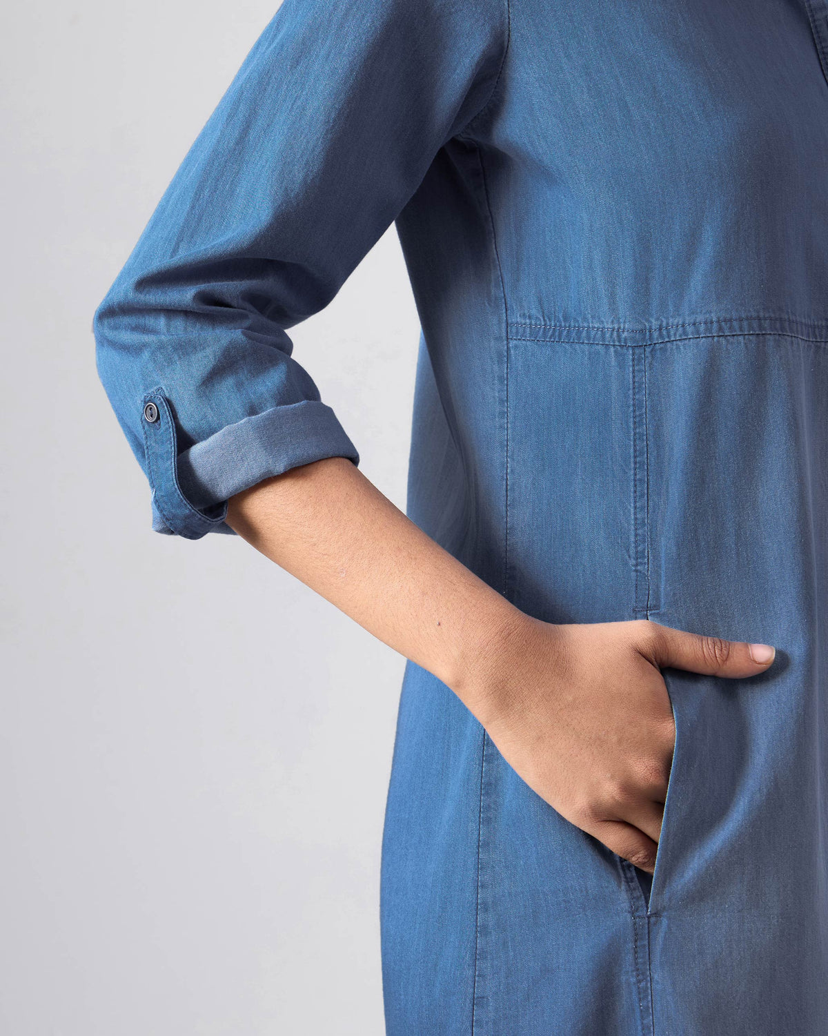 Close-up of a side pocket on a blue Pristine dress.