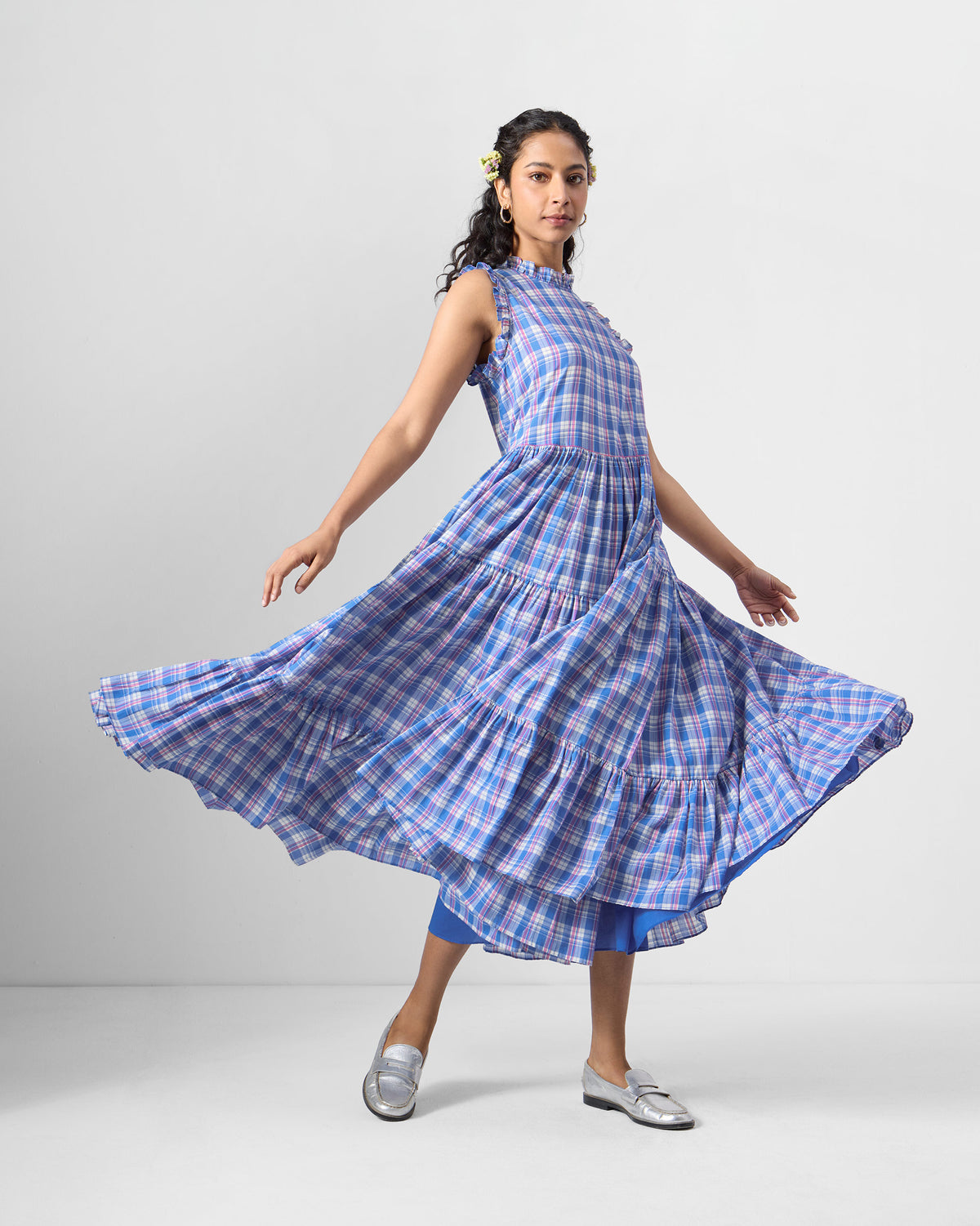 Person spinning in a flared blue checked Reah dress.