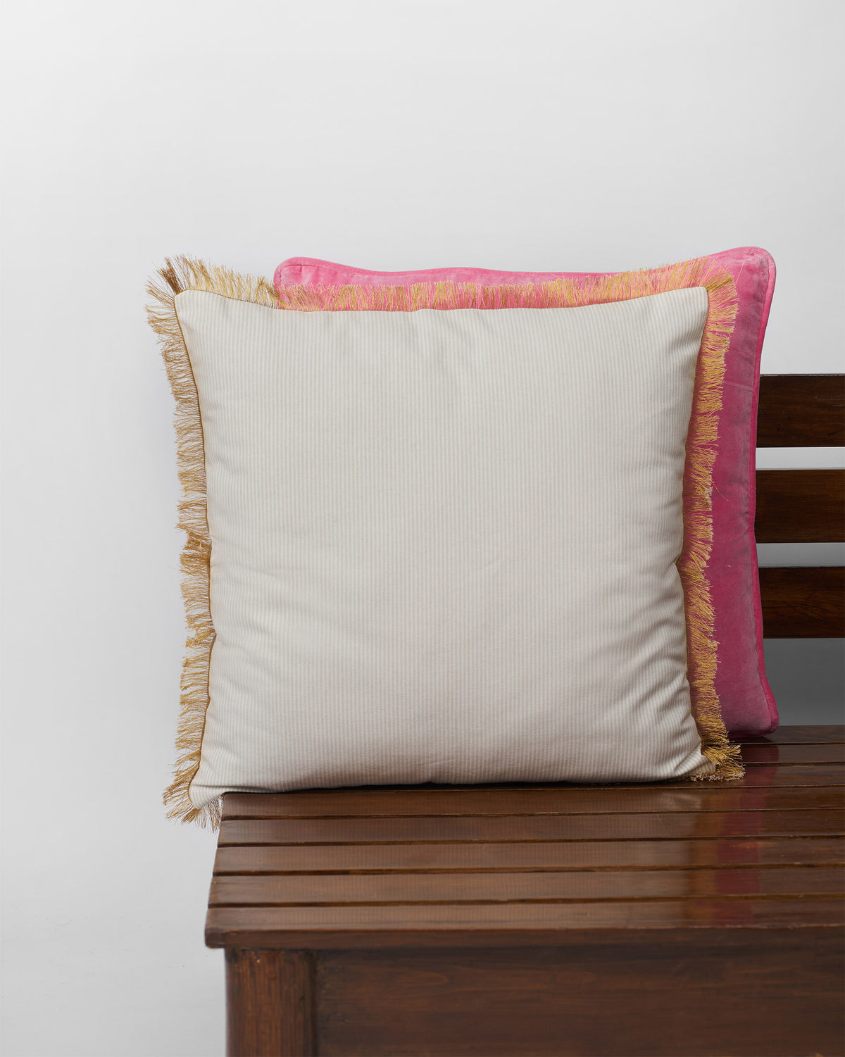 Back of the Gilded Palm Cushion Cover showing its plain cream side and fringed edge.