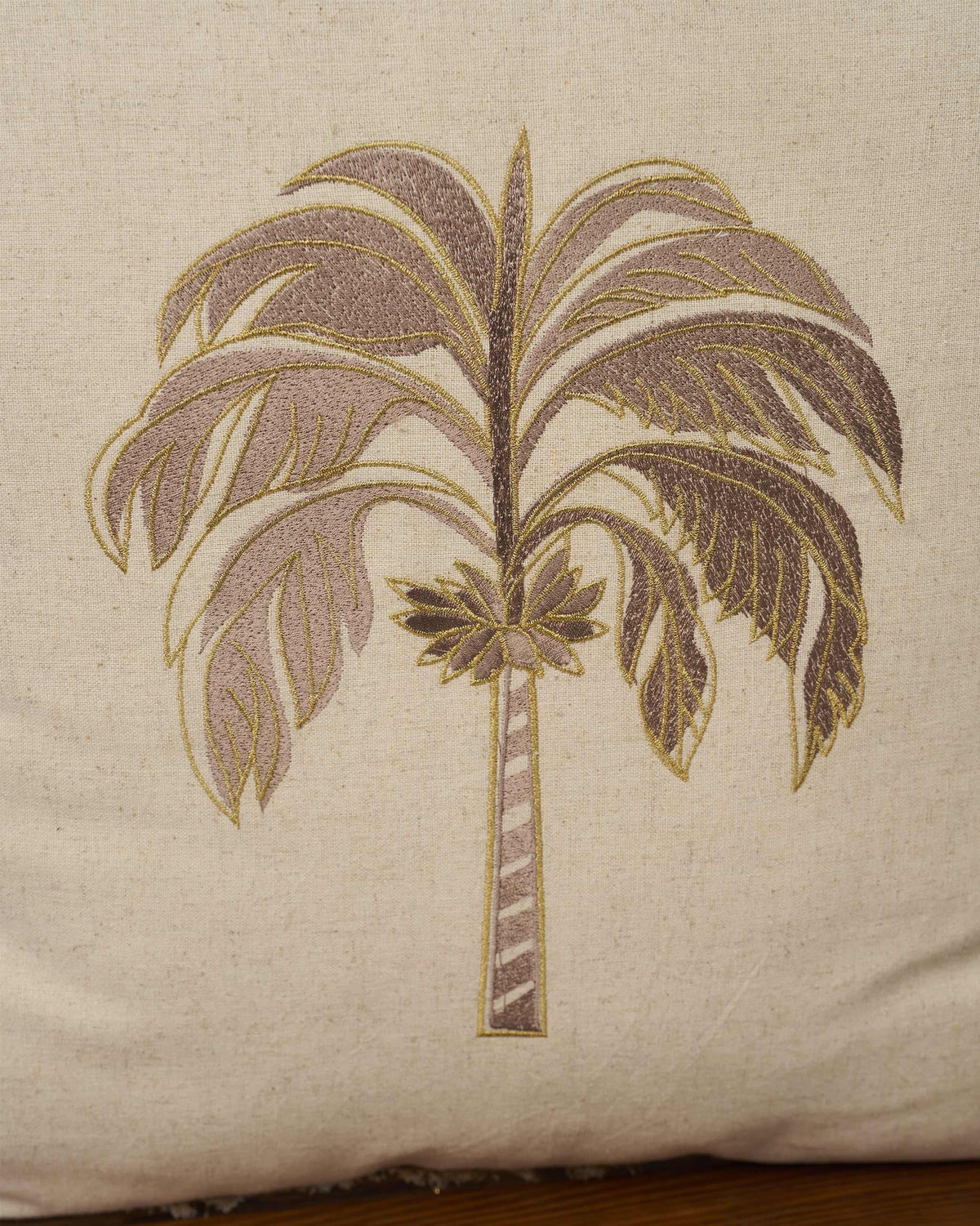 Close-up of the Gilded Palm Cushion Cover showing its embroidered palm tree.