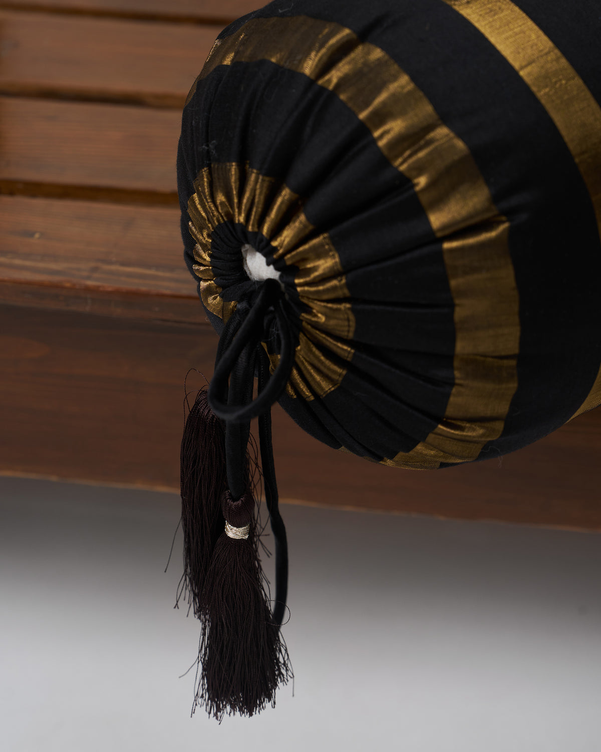 Close-up of Tassel Bolster Cover showing its gathered end and tassel.