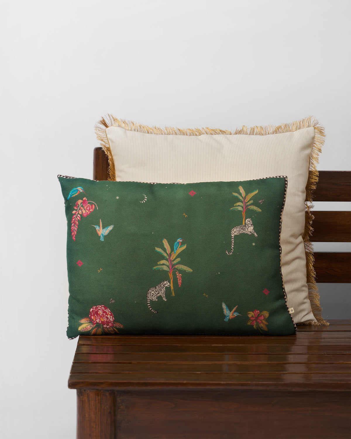 Kingfisher Bloom cushion cover in green with birds, palms and leopards.