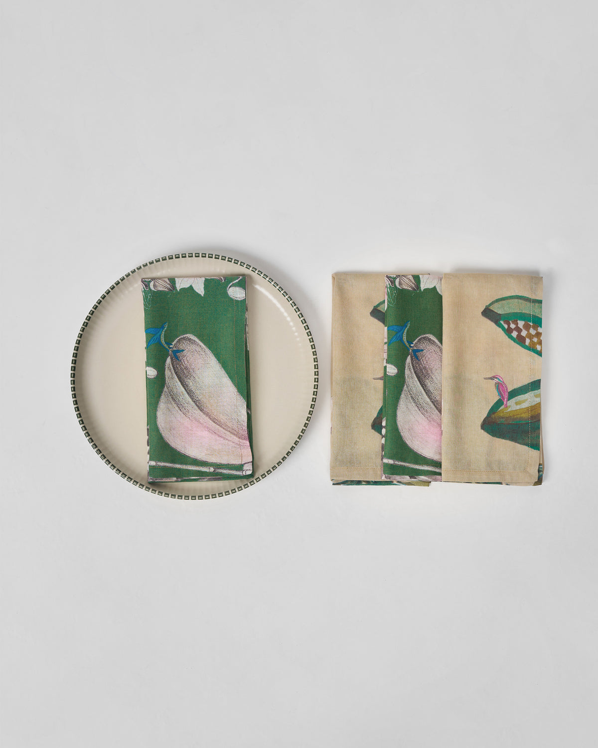 Madhu Napkins in green and cream, one folded on a plate.