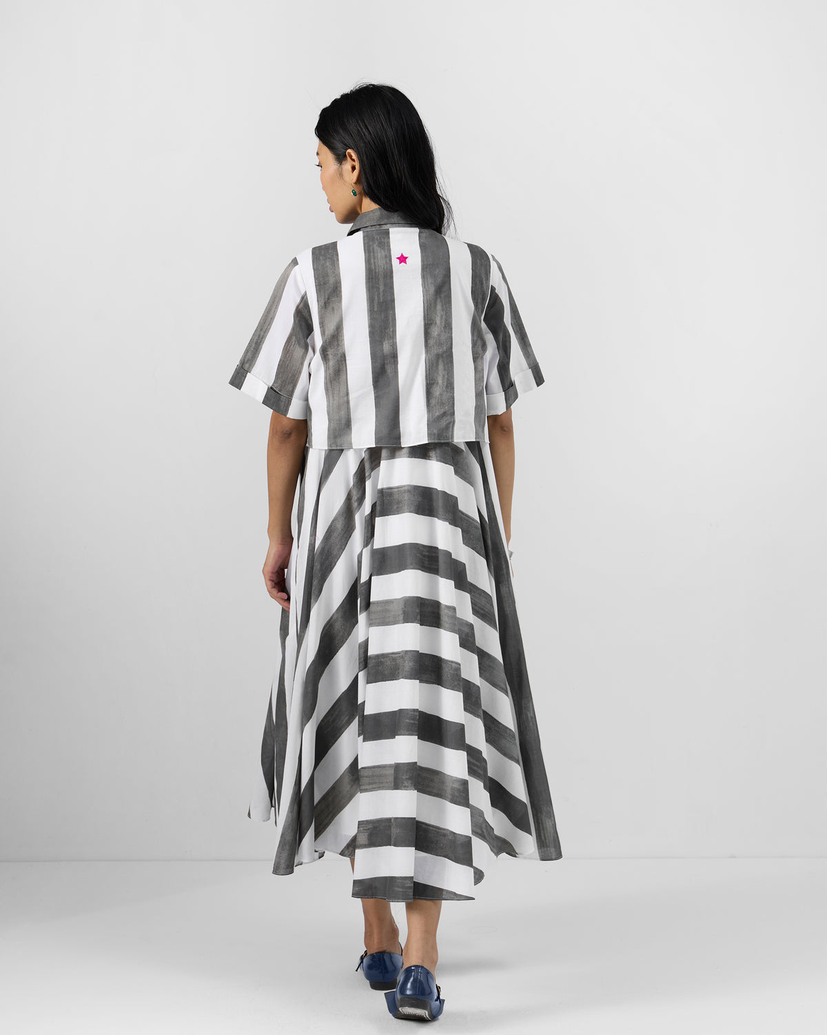 Back of a charcoal and white striped Kuro Dress with a pink star.