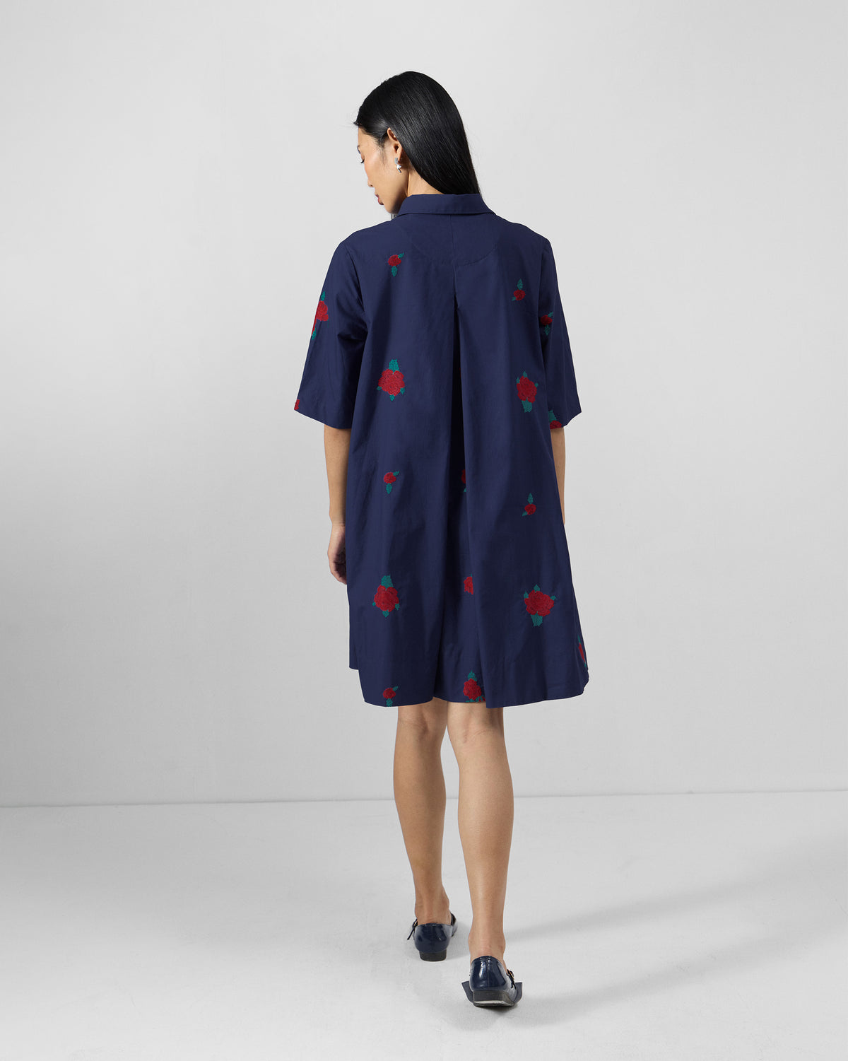 Back of an ink blue Happy Heart Dress showing a yoke and box pleat.
