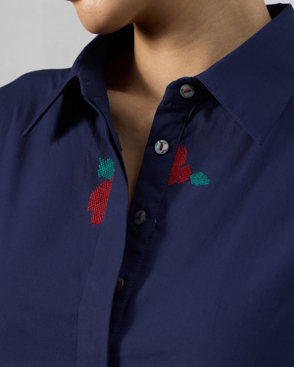 Close-up of the Happy Heart Dress collar with pearl buttons and floral embroidery.
