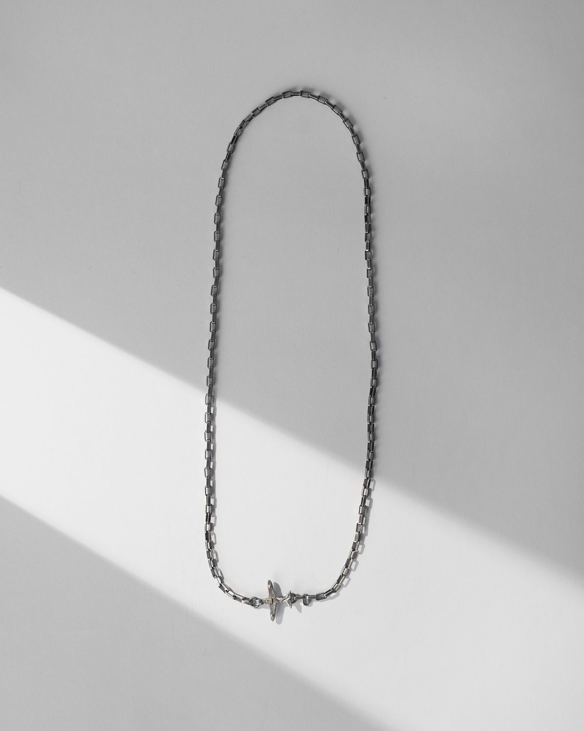 Silver Flight Chain laid in a loop showing rectangular links and a toggle clasp.