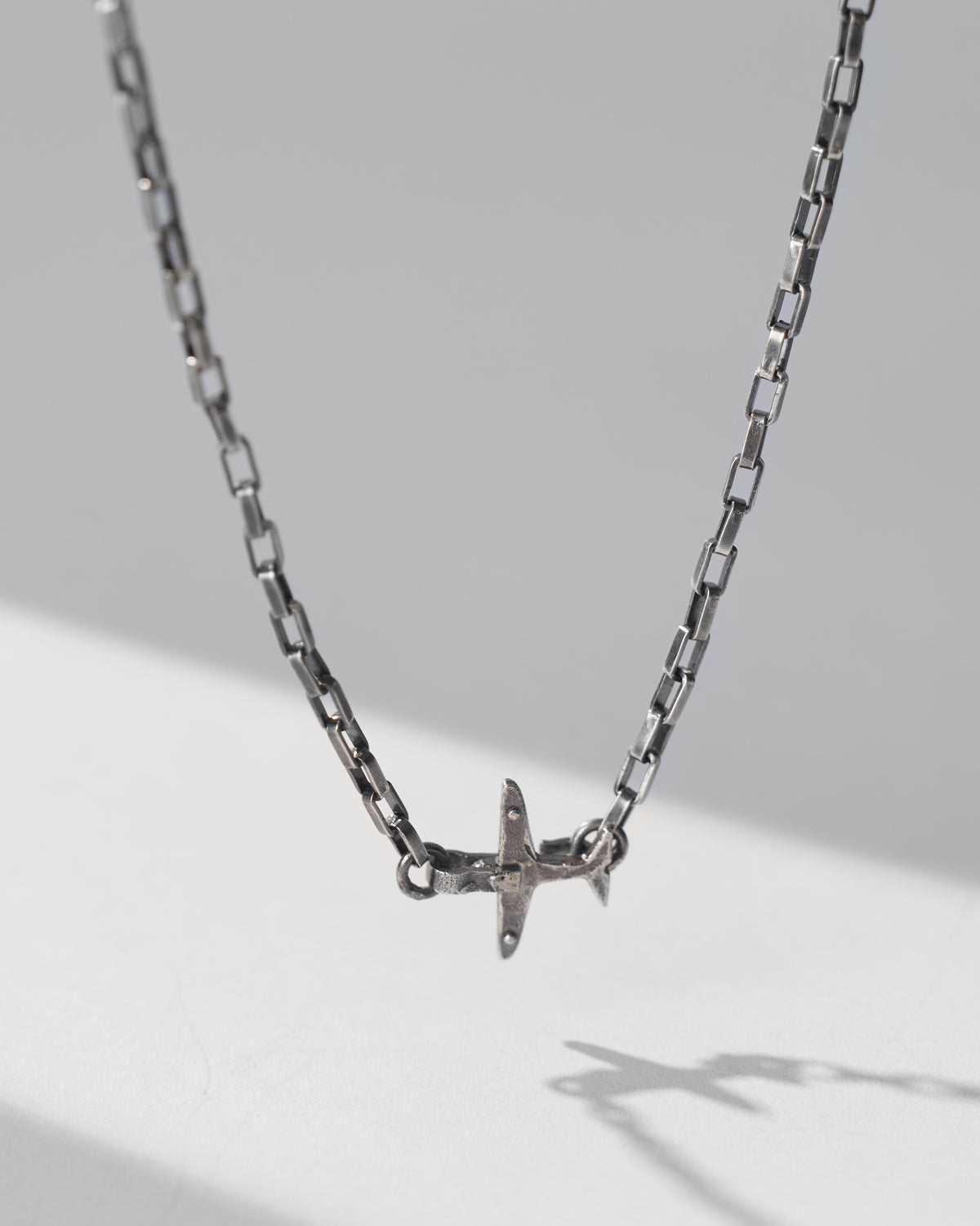 Silver Flight Chain hanging to show the airplane charm at the centre.