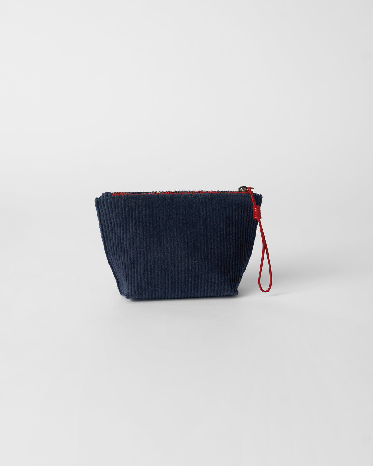 Navy Ditsy coin pouch with a red zipper.
