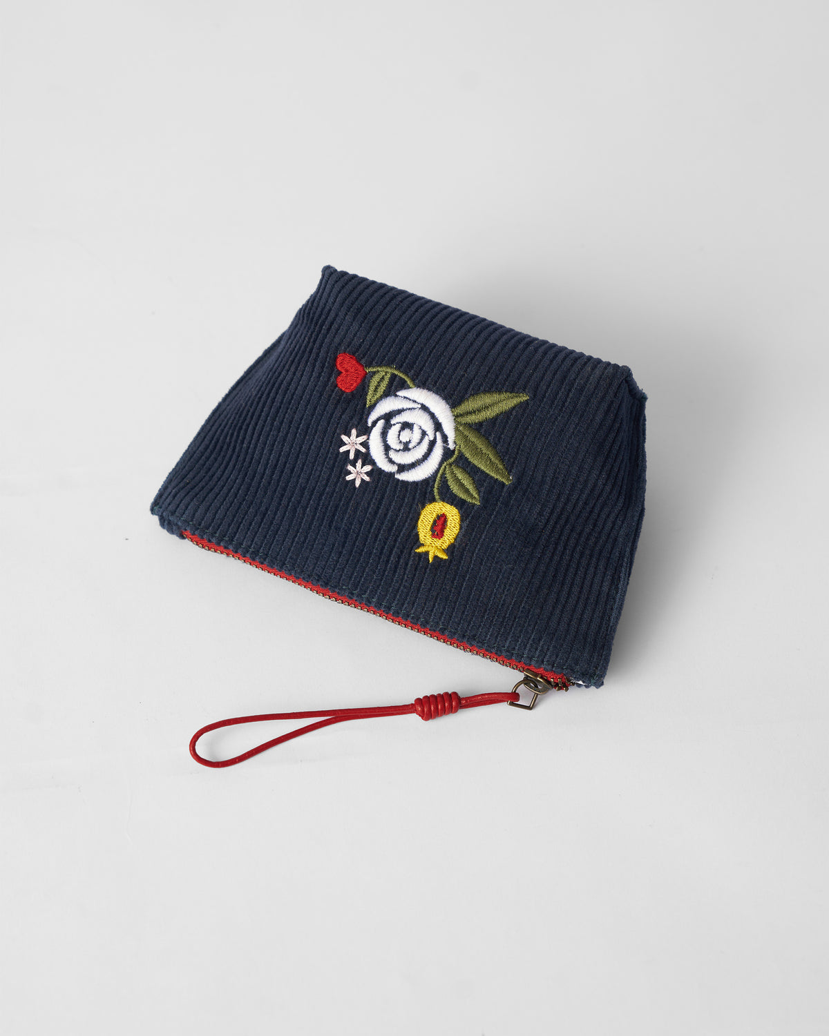 Navy Ditsy coin pouch with white rose embroidery.