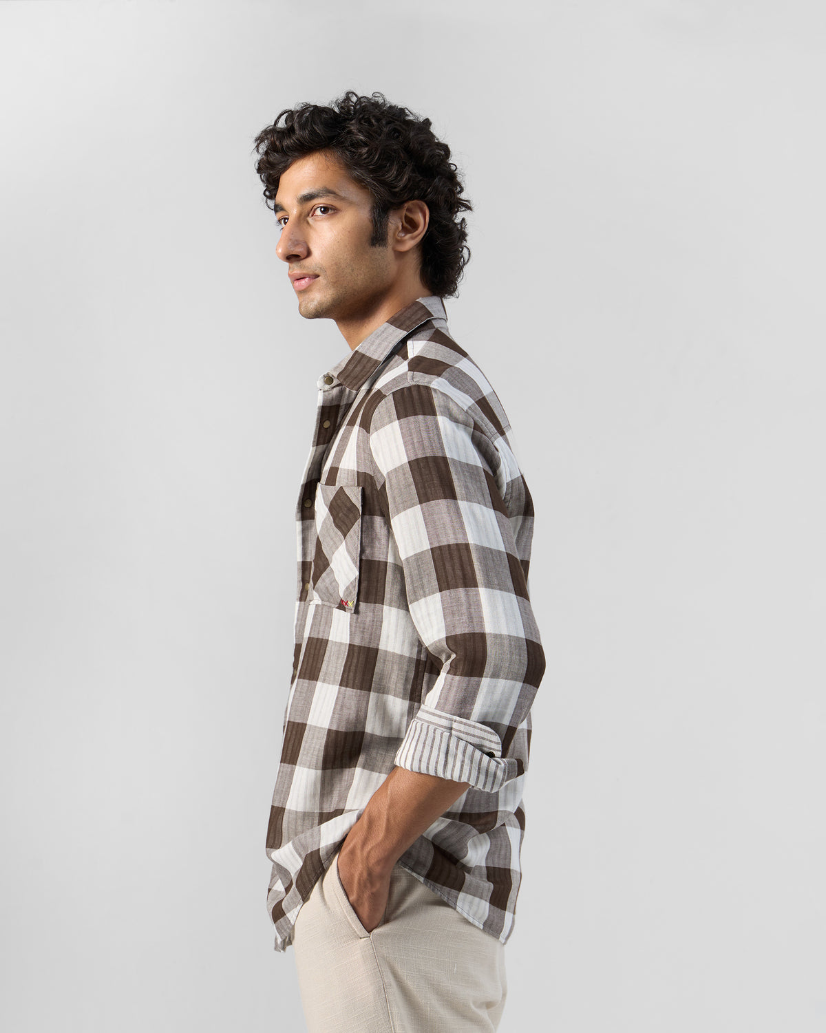 Side view of a brown and white check Milaan shirt.