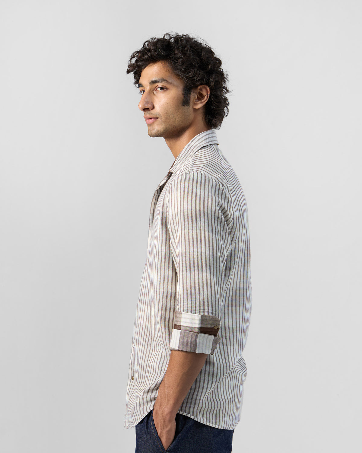 Side view of a beige striped Milaan shirt.