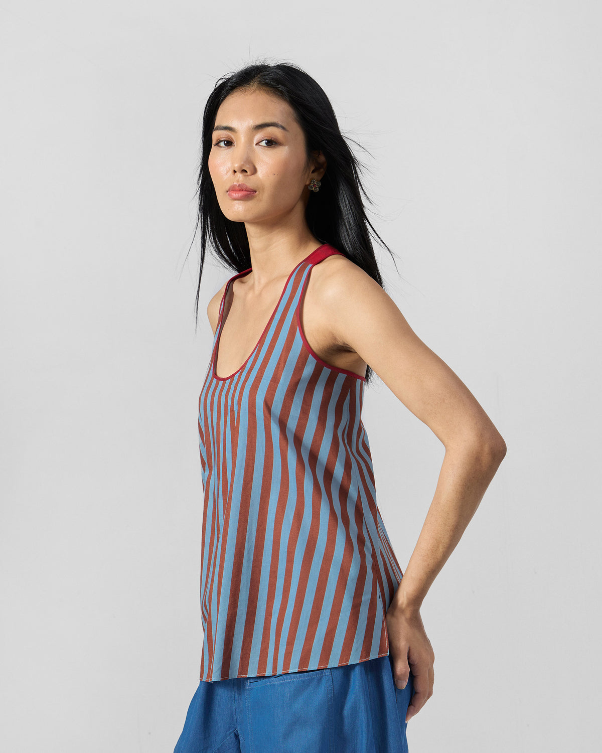 Side view of a blue and brown striped Ukiyo racerback top.
