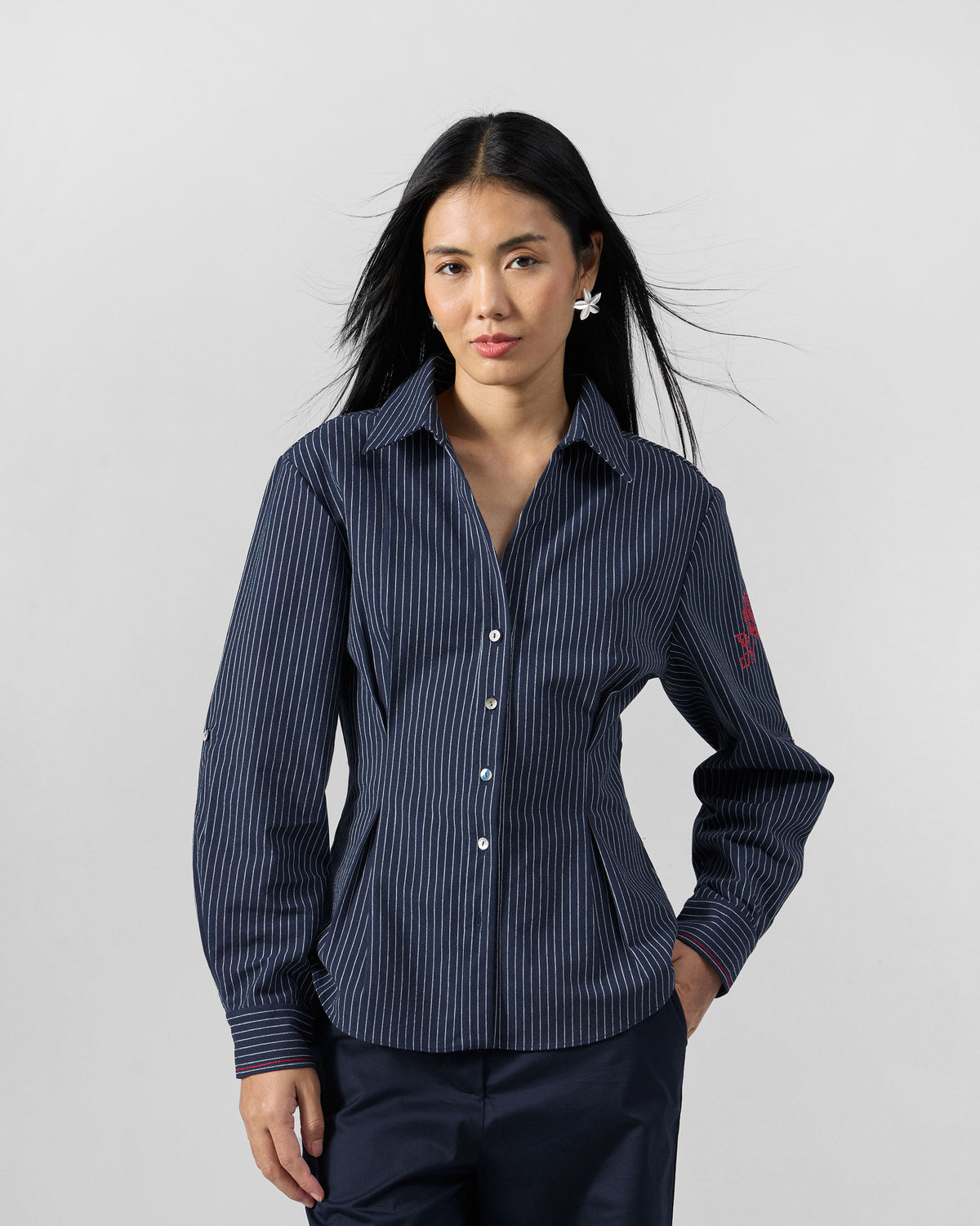 Navy pinstripe Kalo shirt with a red embroidered rose on the sleeve.