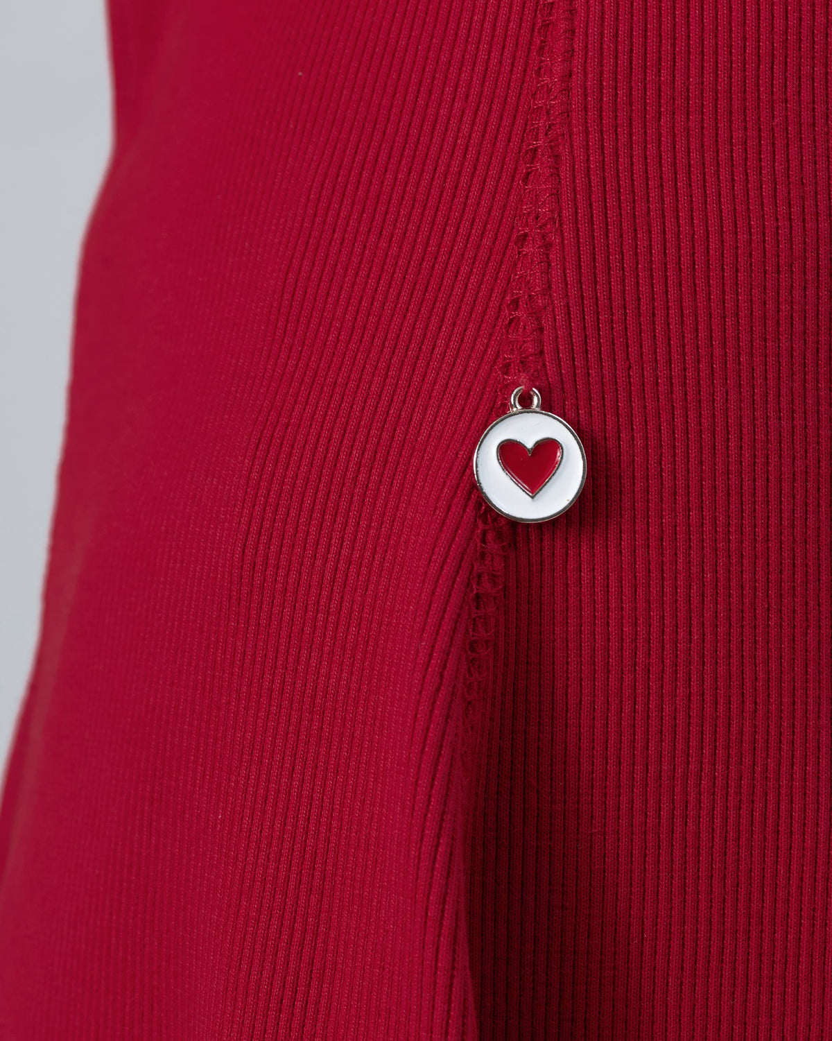 Close-up of a red heart charm on a red Norva skater dress.
