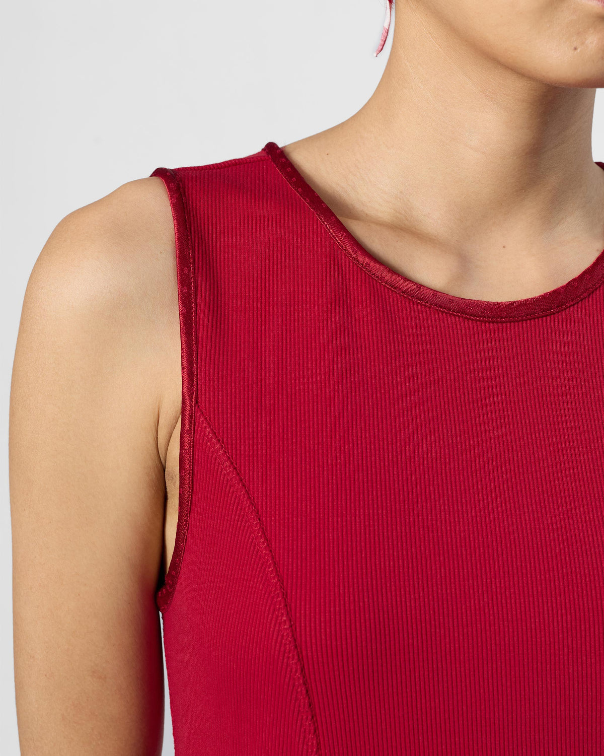 Close-up of ribbed fabric and satin binding on a red Norva skater dress.