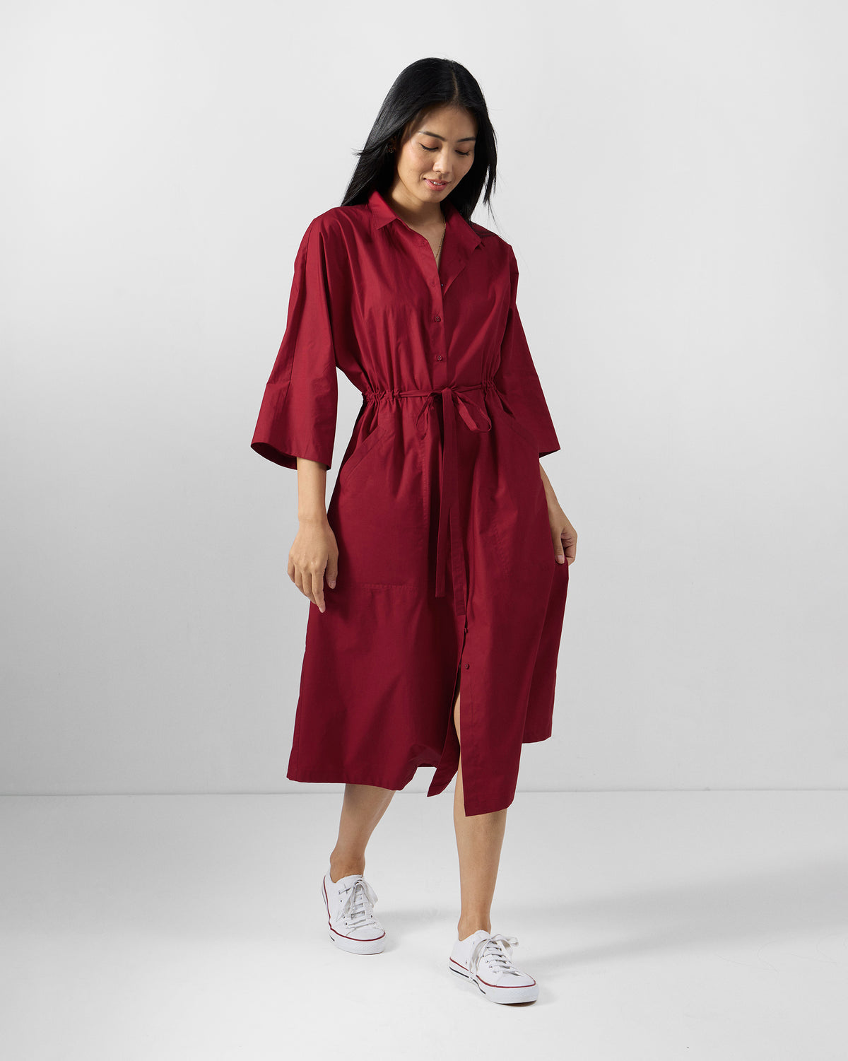 Person wearing a red Nomad shirt dress.