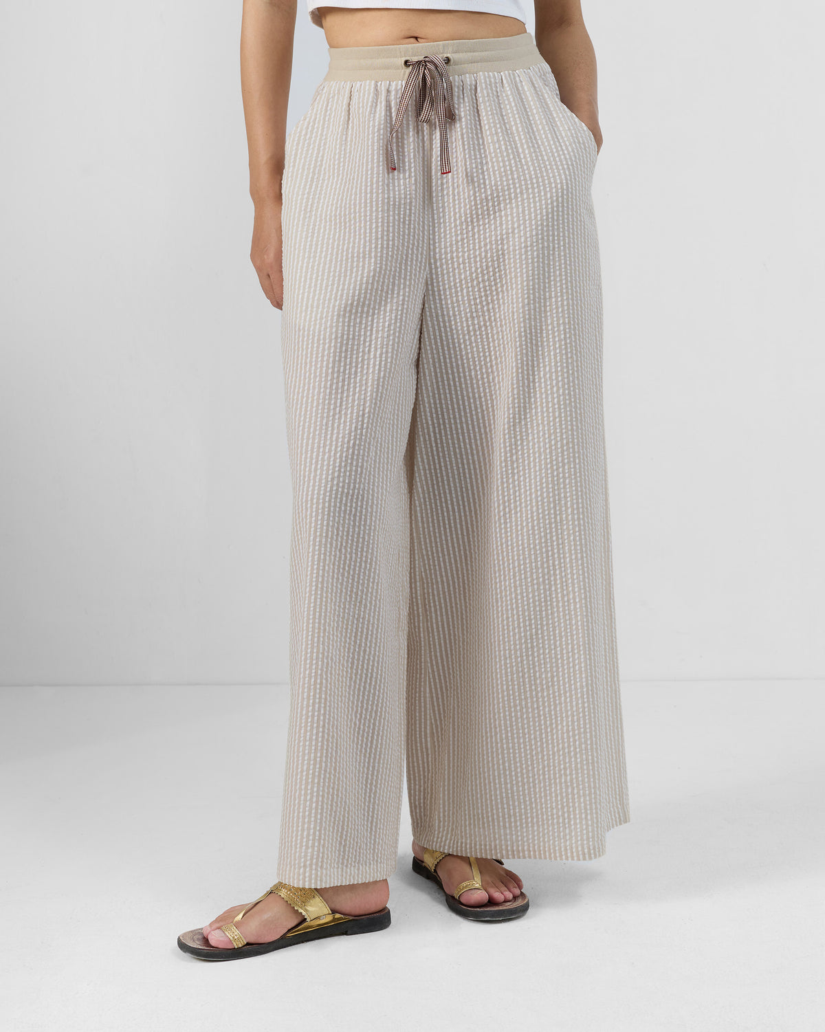 Brown and ivory striped Hera Pants with a flared leg and drawstring waist.