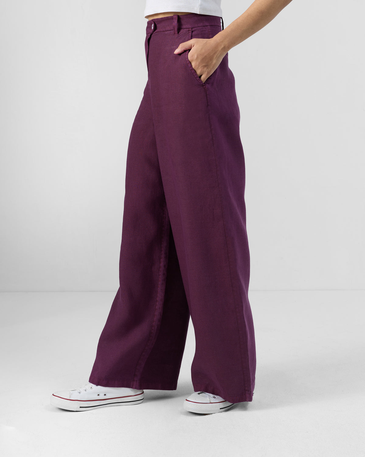 Side view of plum linen Aven pants showing the wide-leg drape.