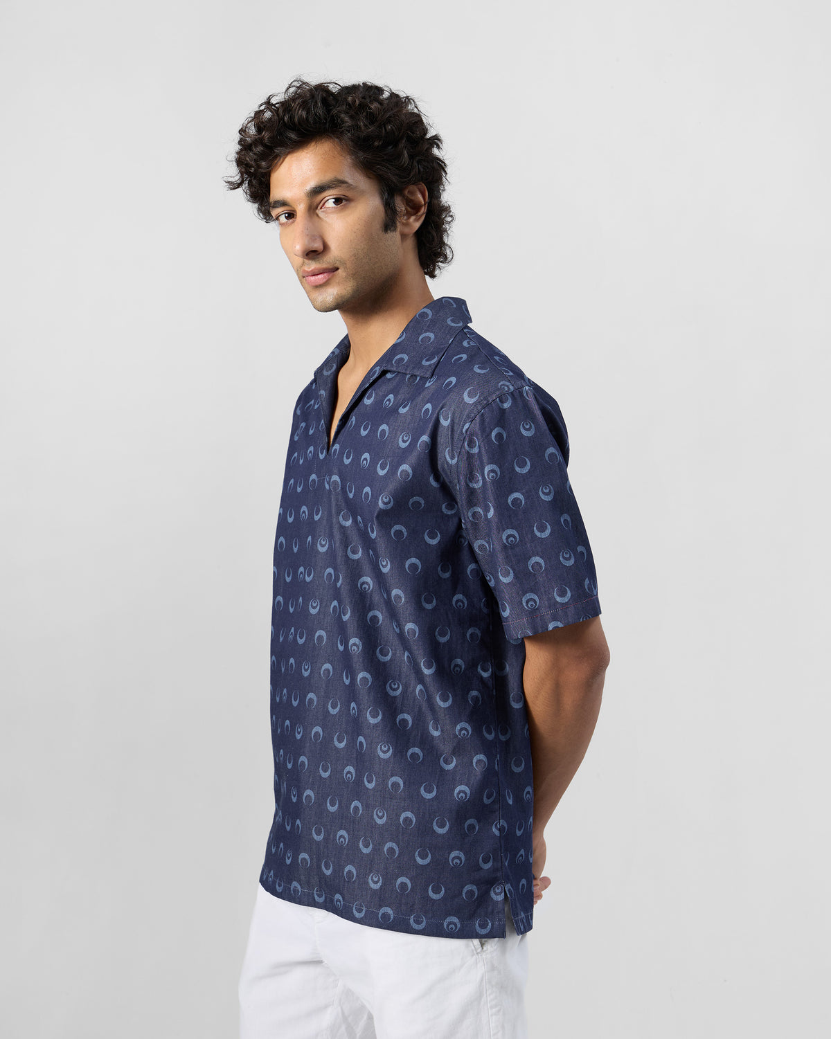 Side view of an indigo Yamuna kurta shirt with moon print.