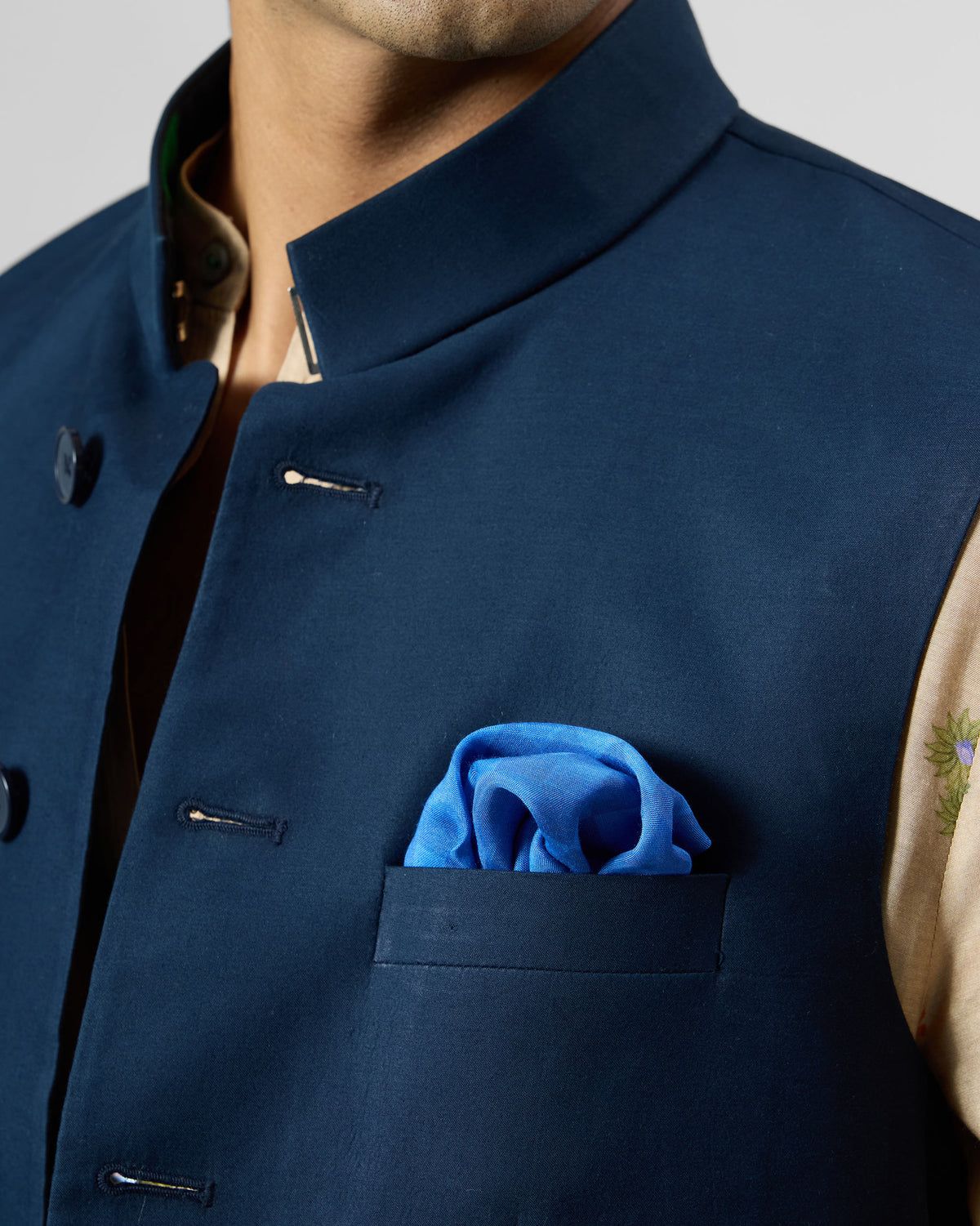 Bright blue Twilight Pocket Square in a puff fold in a navy jacket pocket.