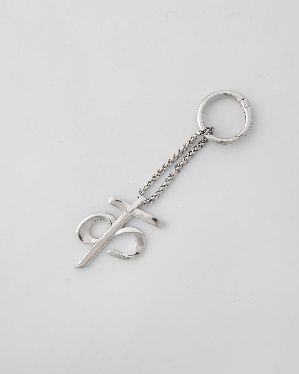 Alphabet K Bag Charm in silver, with chain and clasp ring on a light background.