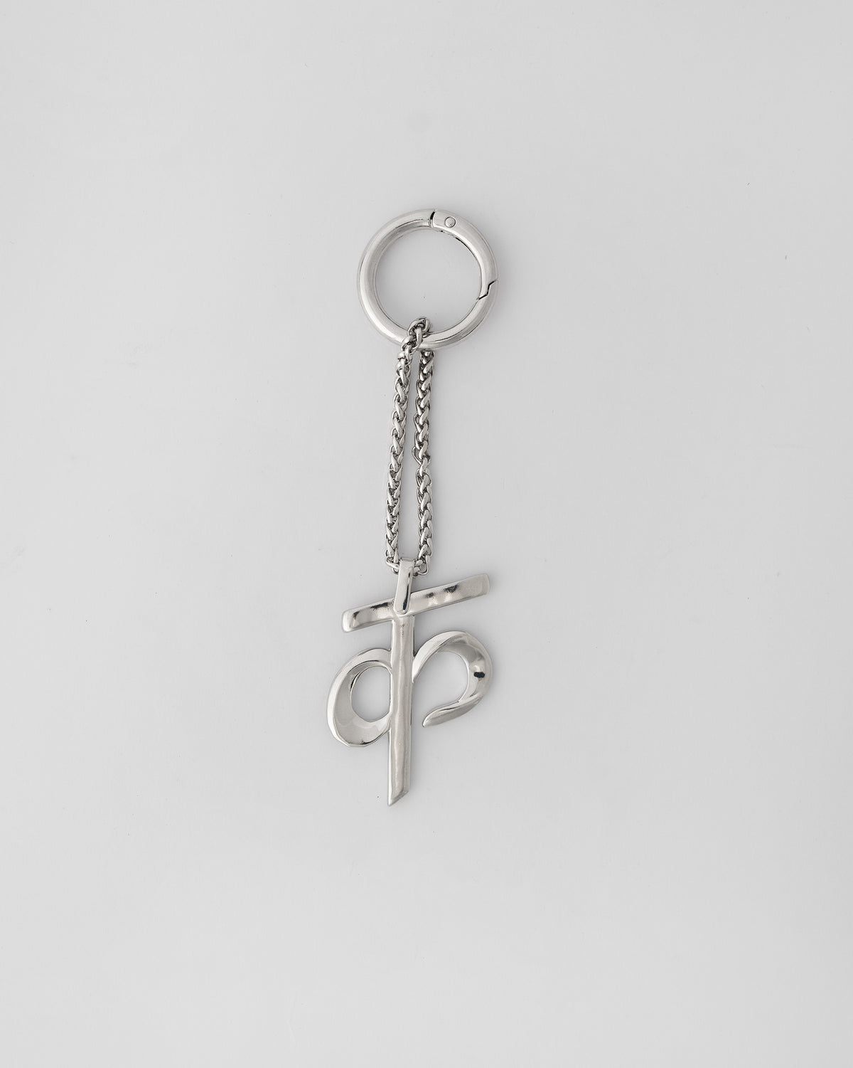 Alphabet K Bag Charm in silver hanging upright from its clasp ring.