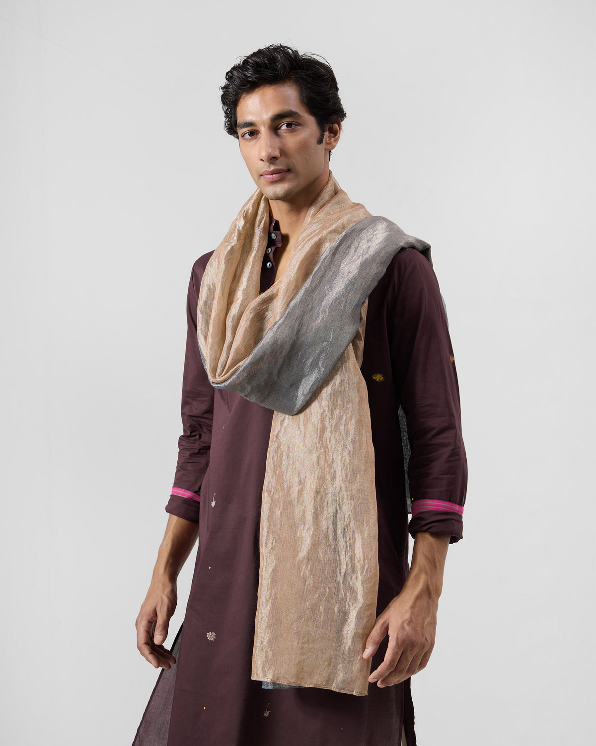Person wearing the Astral Scarf in gold and grey draped around the shoulders.