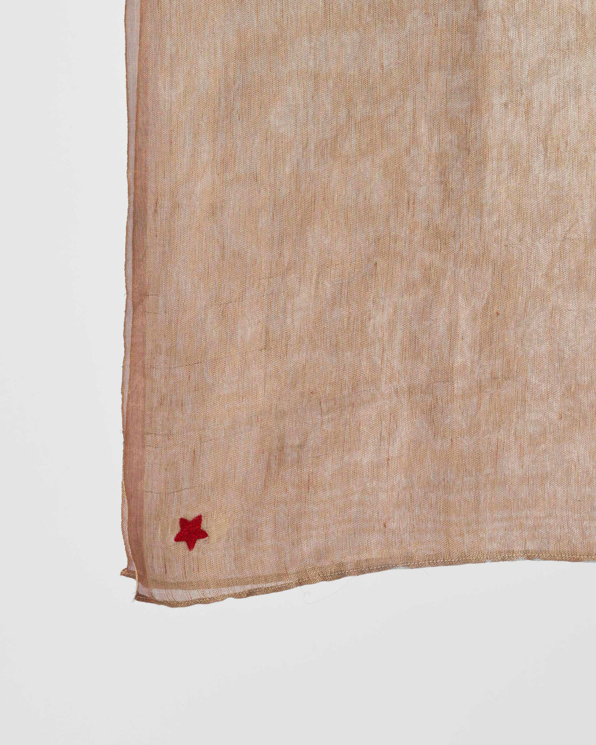 Close-up of the Astral Scarf corner with a small red star.