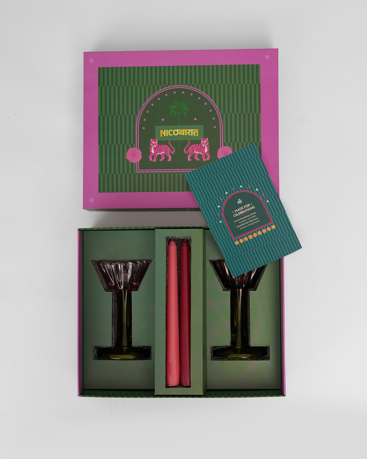 Open Ember gift box with glass candle holders and taper candles inside.