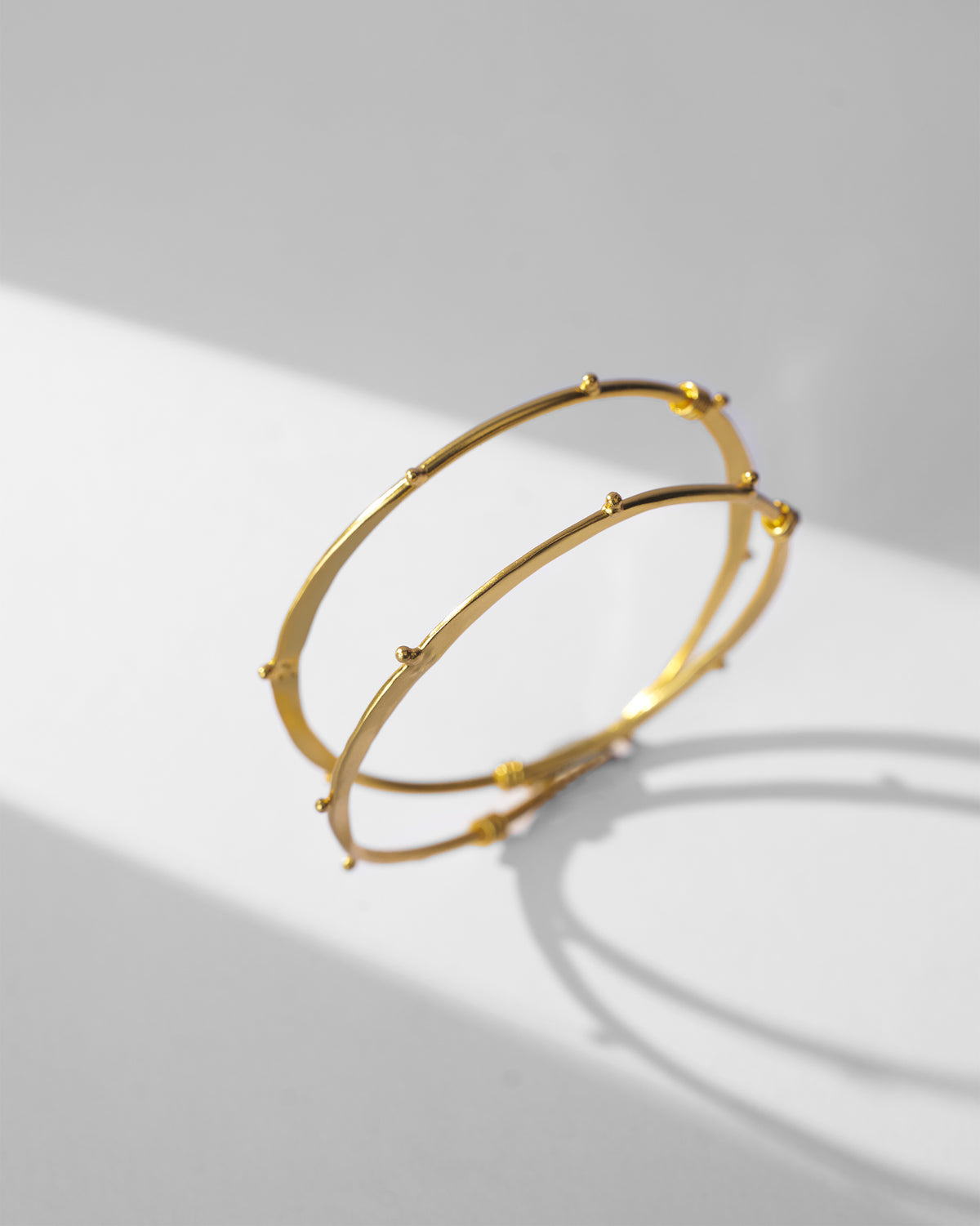 Gold Double Loop Bangle with bead studs and a coiled wire wrap.