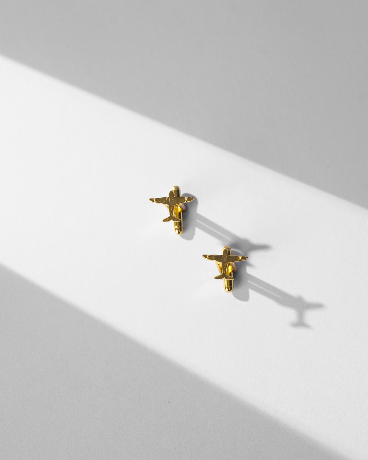 Pair of Flight Cufflinks laid flat on a white surface.