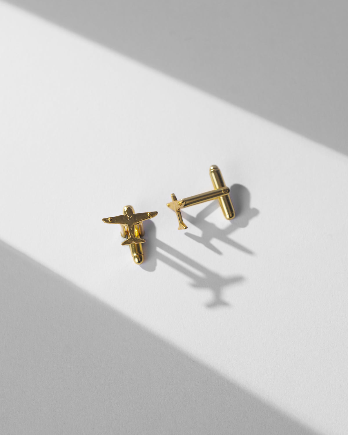 Flight Cufflinks laid flat, one turned to show its back fastening.
