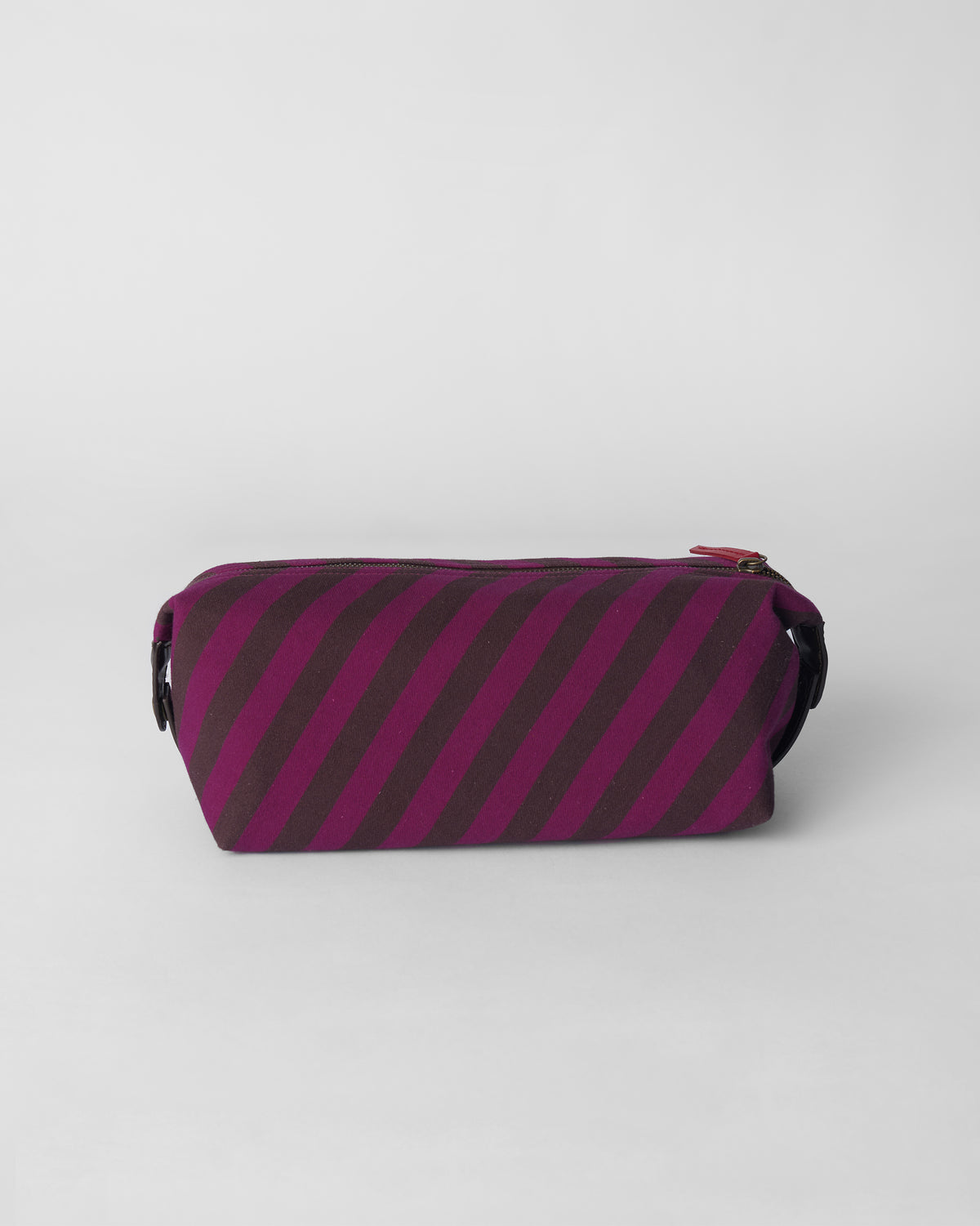 Brown and mulberry diagonally striped Cupid Pouch with a red zipper pull.