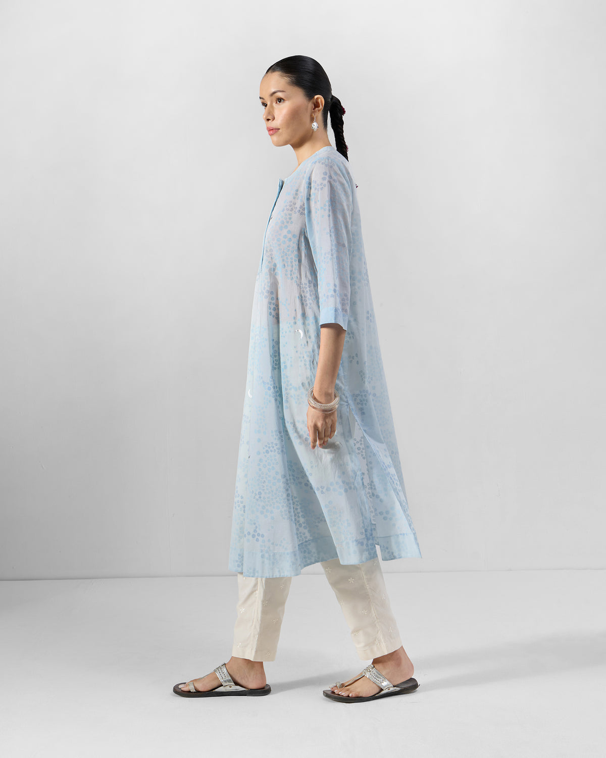 Person wearing a light blue printed kurta in a straight fit.