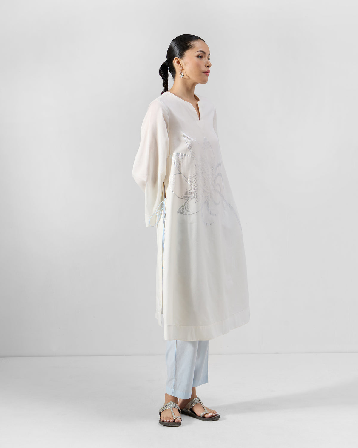 Side view of an ivory Vaya kurta showing the long A-line length and side slits.