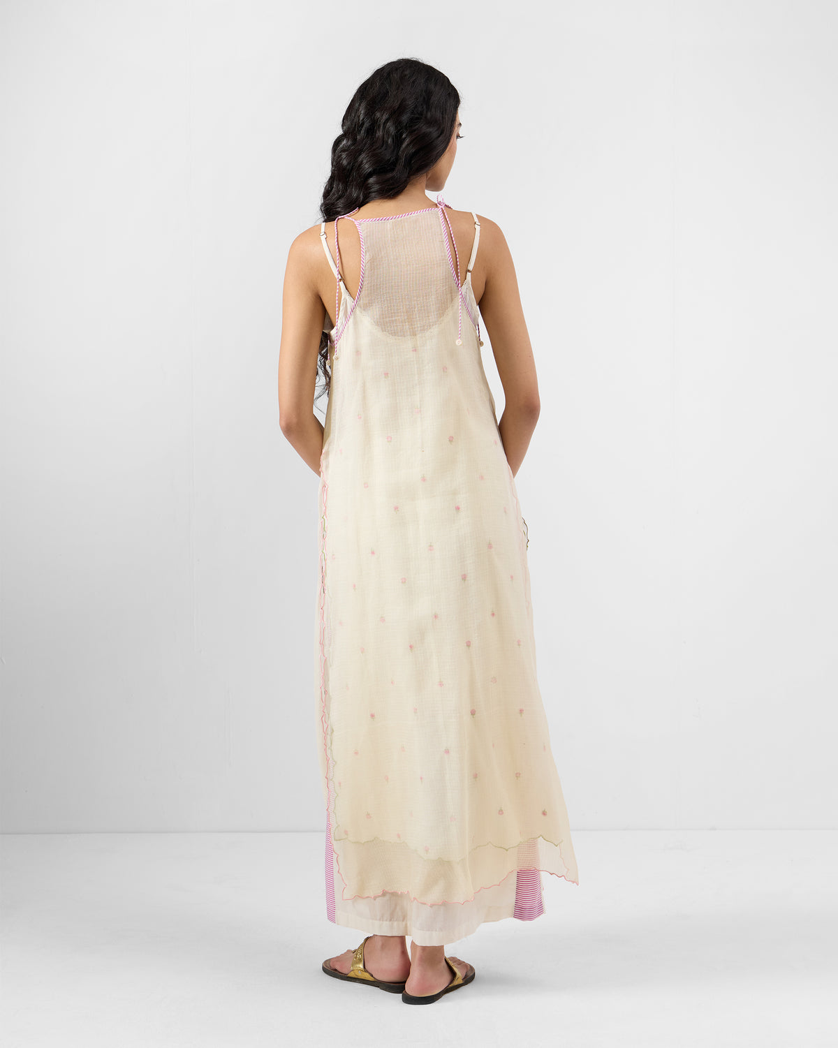 Back of an ivory Hera Halter Kurta showing the mesh racerback and pink piping.