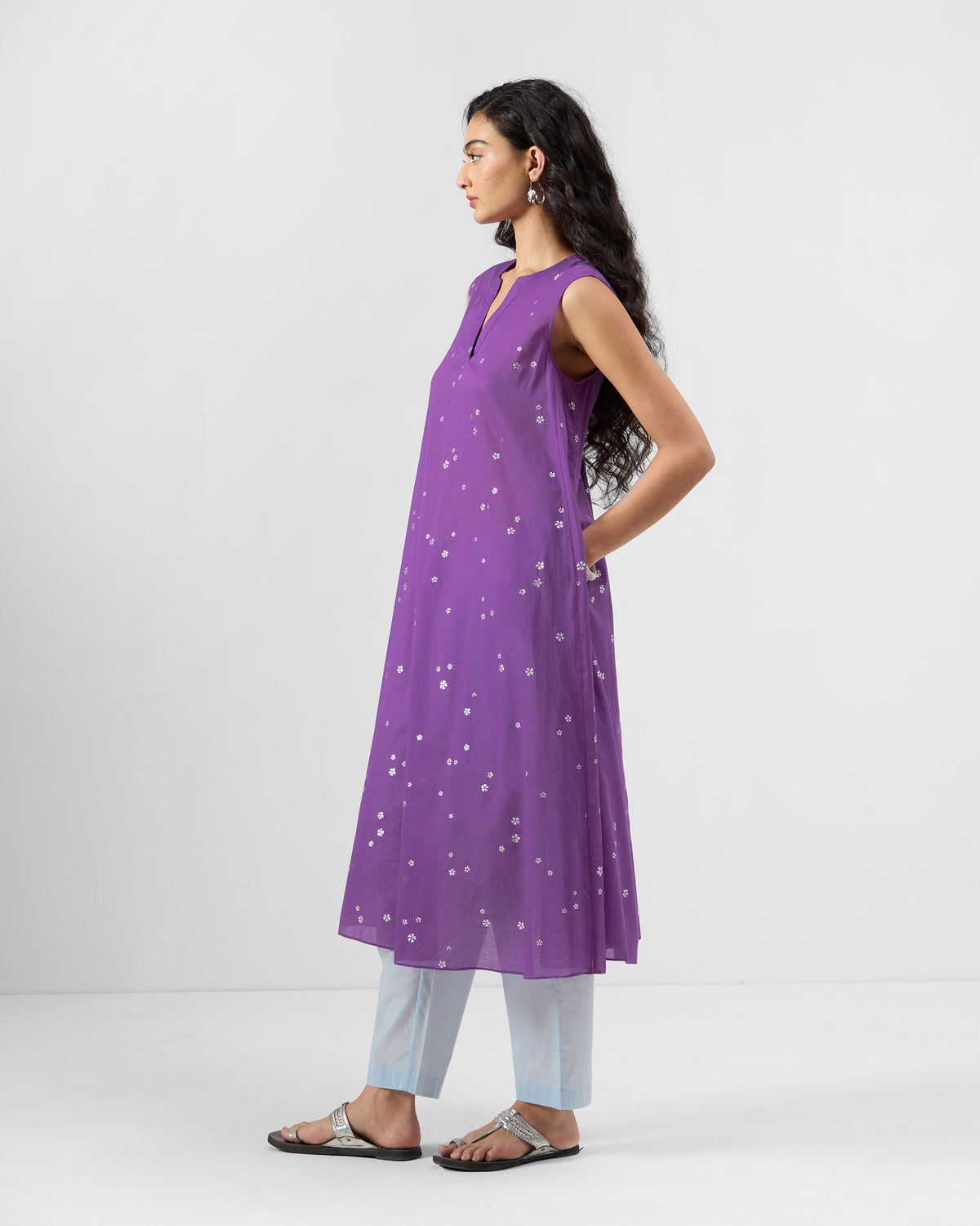 Side view of a purple printed Tuni kurta with a hand in the pocket.