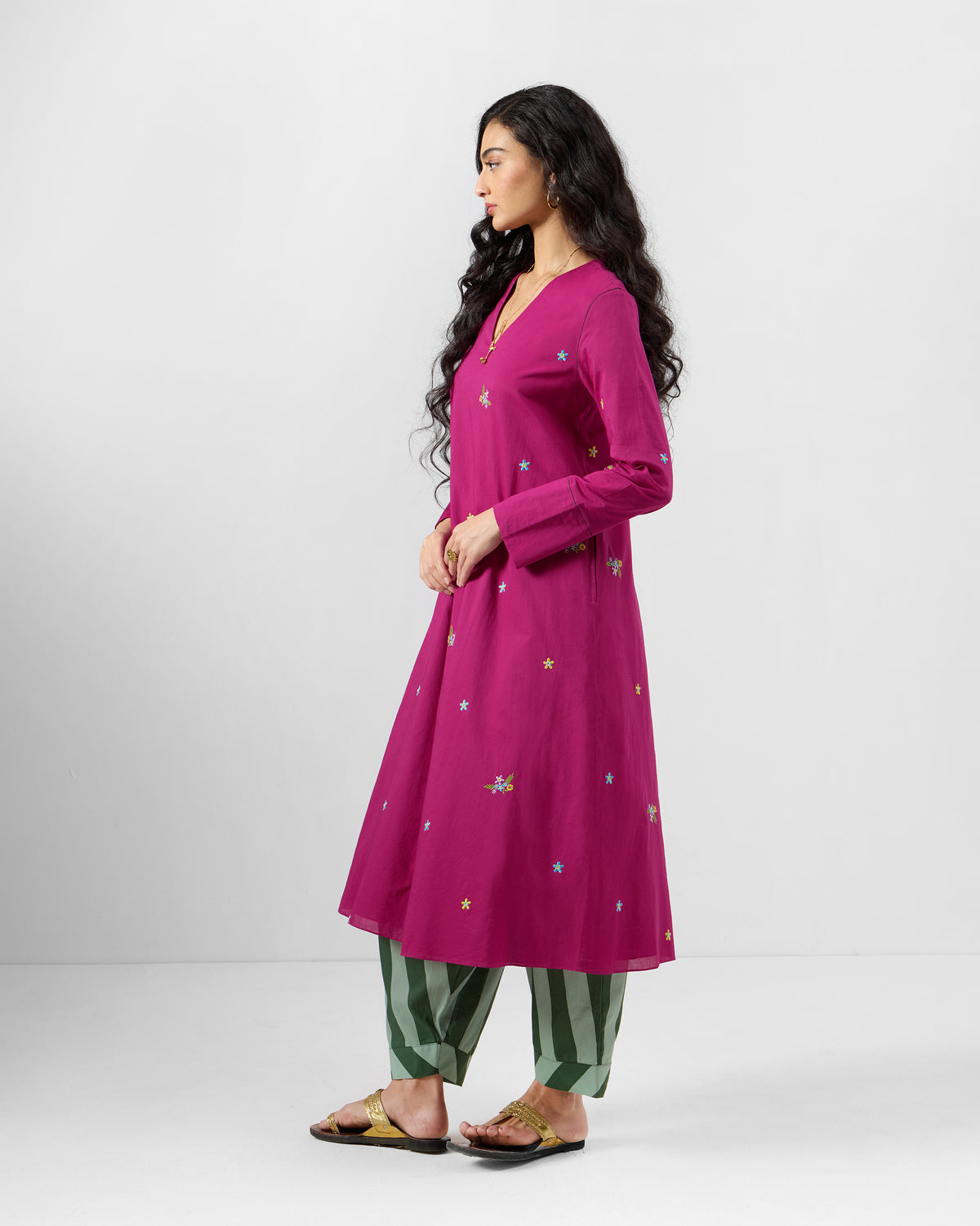 Side view of a berry pink Narsa kurta with floral embroidery.