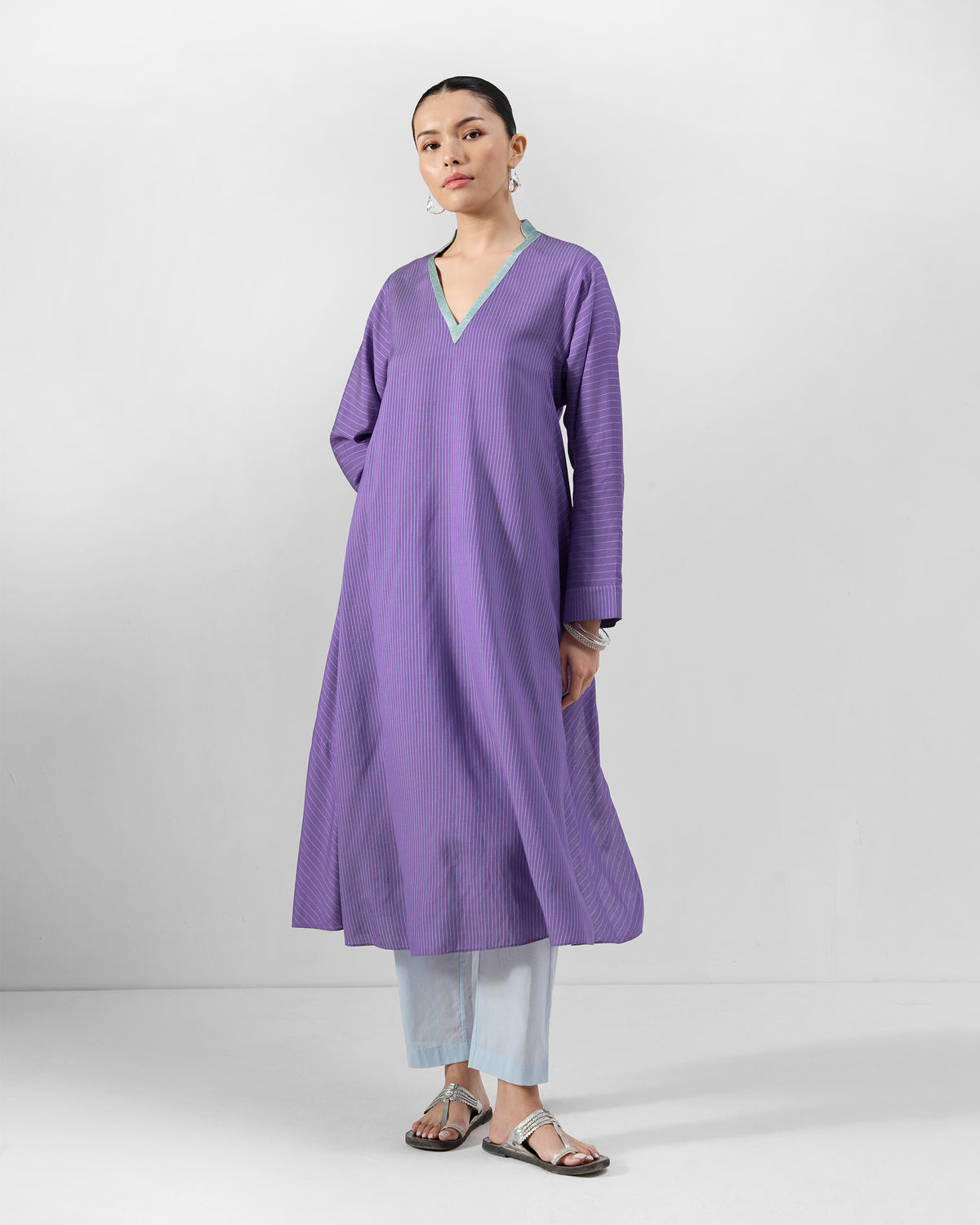 Person wearing a purple Hatiya Kurta with ice blue V-neck trim and A-line length.