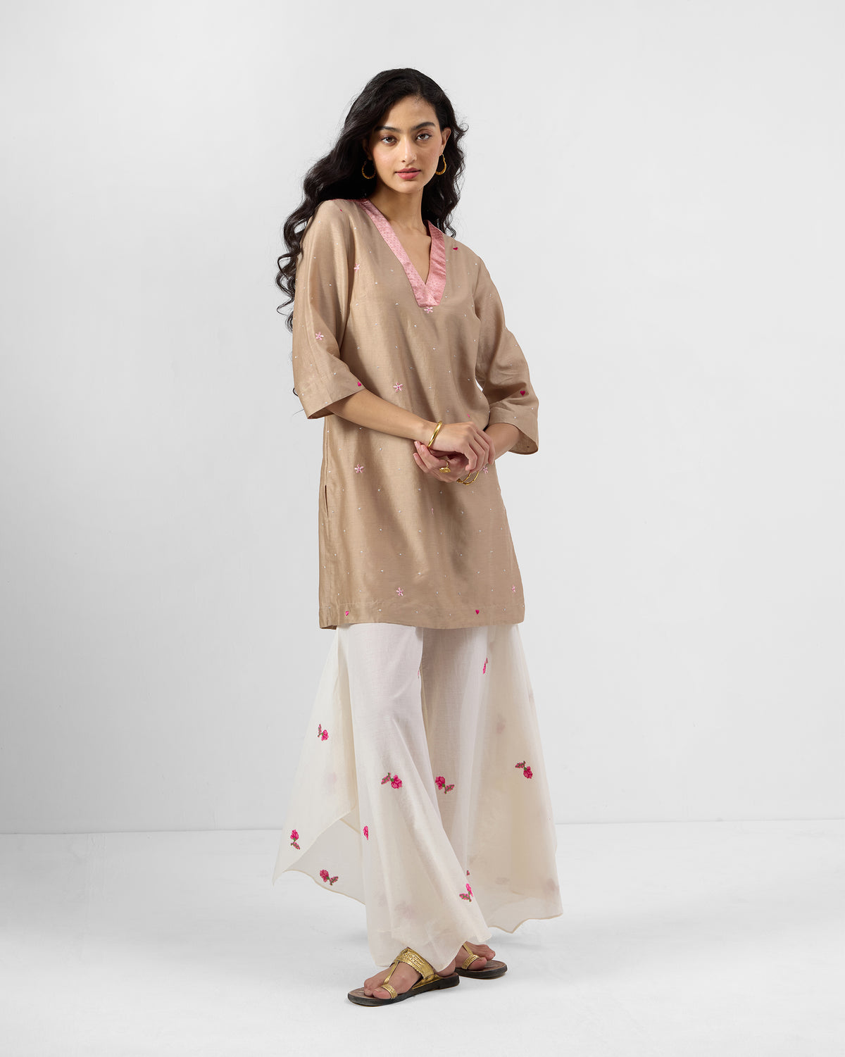 Person wearing a sand and soft pink embroidered Yeles kurta.
