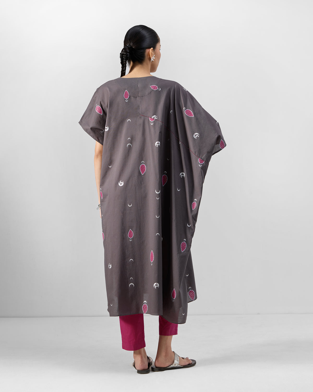 Back of a charcoal Faye Kaftan with wide sleeves and pink scattered motifs.